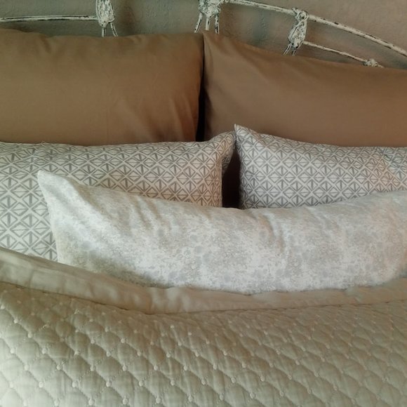 Arrangement of vibrant pillowcases in shades in creams and tans.
